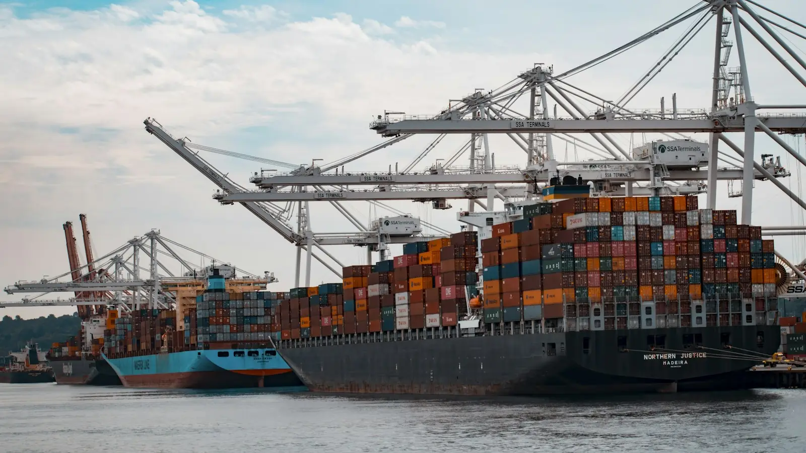 Container ship being loaded by port cranes