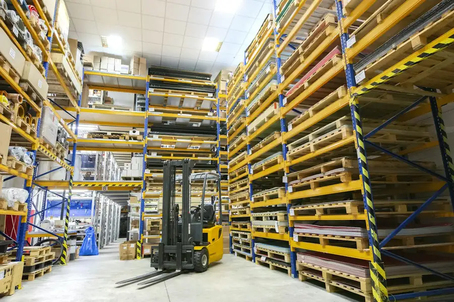 Warehouse racks with pallets and a forklift